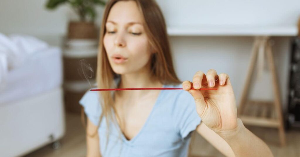  A lady Burning Eucalyptus Incense Stick